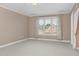 Bright bedroom with carpeted floor, window with blinds, and neutral wall color at 2008 Joelene Dr, Rocky Mount, NC 27803