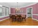 Formal dining room features hardwood floors, elegant chandelier, and natural light from large windows at 2008 Joelene Dr, Rocky Mount, NC 27803
