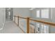 Upstairs hallway with wood railing and carpet at 2008 Joelene Dr, Rocky Mount, NC 27803