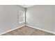 Small carpeted bedroom with neutral walls and a window at 207 Brickwell Way, Youngsville, NC 27596