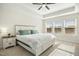 King-size bed in a well-lit bedroom, featuring a ceiling fan at 219 Broadgait Brae Rd, Cary, NC 27519