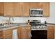 Kitchen with wood cabinets, gas range and microwave at 219 Broadgait Brae Rd, Cary, NC 27519