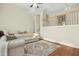 Living room with hardwood floors, sectional sofa, and view of upper level at 219 Broadgait Brae Rd, Cary, NC 27519