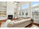 Living room with fireplace and large windows at 219 Broadgait Brae Rd, Cary, NC 27519