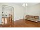 Living room with hardwood floors, and view into kitchen area at 219 Broadgait Brae Rd, Cary, NC 27519