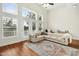 Bright living room features high ceilings, large windows and a comfortable seating area with hardwood floors at 219 Broadgait Brae Rd, Cary, NC 27519