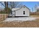 Fenced backyard with a small deck and patchy snow cover at 2305 Ashe St, Durham, NC 27703