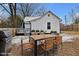 Backyard patio with wooden table and chairs, gas grill and small plants at 2305 Ashe St, Durham, NC 27703