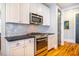 Modern kitchen with white cabinets, stainless steel appliances and hexagon backsplash at 2494 Briar Chapel Pkwy, Chapel Hill, NC 27516