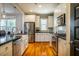 Modern kitchen with white cabinets, stainless steel appliances, and an island at 2494 Briar Chapel Pkwy, Chapel Hill, NC 27516