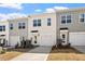 Townhome exterior featuring attached garages, well-kept lawns and walkways at 284 Chesapeake Commons St # 150, Garner, NC 27529