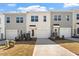 A modern townhome featuring a one-car garage and neutral siding with a concrete driveway and manicured landscaping at 284 Chesapeake Commons St # 150, Garner, NC 27529