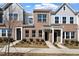 Newly constructed townhomes with a mix of brick and siding and manicured lawns at 284 Chesapeake Commons St # 150, Garner, NC 27529