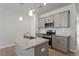 Modern kitchen featuring a granite island, stainless steel appliances, and modern cabinets at 284 Chesapeake Commons St # 150, Garner, NC 27529