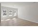 Spacious open-concept living room featuring wood-look floors and natural light at 284 Chesapeake Commons St # 150, Garner, NC 27529
