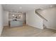 Open-concept kitchen and living room with stainless appliances and stairs to the upper level at 284 Chesapeake Commons St # 150, Garner, NC 27529