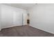 Bedroom with neutral walls, carpet, and open doorway to a bathroom at 288 Chesapeake Commons St # 149, Garner, NC 27529