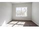 Bright bedroom featuring neutral walls, carpet, and a large window with neighborhood view at 288 Chesapeake Commons St # 149, Garner, NC 27529
