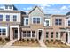 Charming townhouse with a brick facade, symmetrical windows, and manicured landscaping in a suburban neighborhood at 288 Chesapeake Commons St # 149, Garner, NC 27529