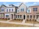 Charming townhouse with a brick facade, symmetrical windows, and manicured landscaping in a suburban neighborhood at 288 Chesapeake Commons St # 149, Garner, NC 27529