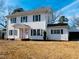 Two story white house with classic design, front porch, and detached garage at 301 N Ellis Ave, Dunn, NC 28334