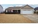 Tan house with red shutters, a white garage door, and a manicured lawn at 411 Joneshaven Dr, Fuquay Varina, NC 27526