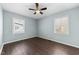 Light and airy bedroom with two windows and wood flooring at 4816 Connell Dr, Raleigh, NC 27612