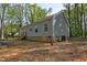 Rear view of a single-Gathering home with siding and a small basement window at 512-A E Graham St, Mebane, NC 27302