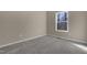 Bright bedroom features plush carpet, neutral walls, and a large window view at 512-A E Graham St, Mebane, NC 27302