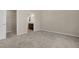 Bright bedroom features plush carpet, neutral walls, and doorway view to the ensuite bathroom at 512-A E Graham St, Mebane, NC 27302