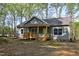 Inviting one-story home with a covered front porch and natural surroundings at 512-A E Graham St, Mebane, NC 27302