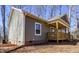 Side view of house showcasing gray siding and wooden porch at 512-A E Graham St, Mebane, NC 27302