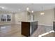 Open concept eat-in kitchen with a center island featuring granite countertops and pendant lighting at 512-A E Graham St, Mebane, NC 27302