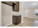 Kitchenette features a granite countertop, dark wood cabinets, and laundry hookups at 512-A E Graham St, Mebane, NC 27302