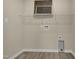 Functional laundry area with laminate floors, wire shelving, and utility connections, ready for appliances at 512-A E Graham St, Mebane, NC 27302
