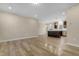 Open-concept living area with wood-look floors, and a view of the kitchen with a center island at 512-A E Graham St, Mebane, NC 27302