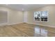 Spacious living room with wood-look flooring, a large window, and neutral walls perfect for new decor at 512-A E Graham St, Mebane, NC 27302