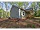 Well-maintained home with light green siding, nestled amongst mature trees at 512-A E Graham St, Mebane, NC 27302