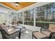 Bright sunroom featuring wicker furniture and tranquil wooded views at 5736 Manor Plantation Dr, Raleigh, NC 27603