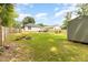 Green backyard with firepit and storage shed at 619 Barbour St, Clayton, NC 27520