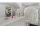 Bathroom with double vanity and patterned shower curtain at 619 Barbour St, Clayton, NC 27520