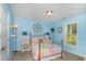 Bedroom with light blue walls and metal bed frame at 619 Barbour St, Clayton, NC 27520