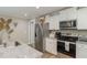 White shaker cabinets, stainless steel appliances, and granite countertops at 619 Barbour St, Clayton, NC 27520