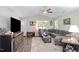 Spacious living room with a gray sectional sofa and wood-look floors at 619 Barbour St, Clayton, NC 27520
