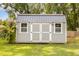 Gray storage shed with double doors and windows at 619 Barbour St, Clayton, NC 27520