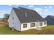 Spacious backyard with ample grass and an exterior view of the home's siding and windows at 66 Tennyson Dr, Garner, NC 27529