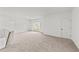 Large and bright carpeted bonus room with white walls and a window providing natural light at 66 Tennyson Dr, Garner, NC 27529