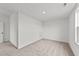 Cozy carpeted room featuring a small door and a window for natural lighting at 66 Tennyson Dr, Garner, NC 27529