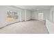 Spacious carpeted bonus room with a large window for ample natural light at 66 Tennyson Dr, Garner, NC 27529