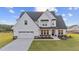 Charming two-story home with a 2-car garage, black accents and neatly manicured lawn at 66 Tennyson Dr, Garner, NC 27529
